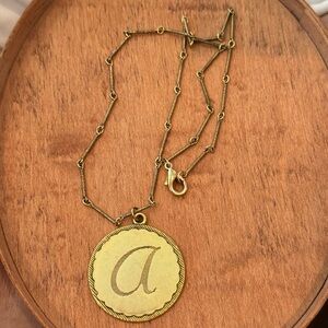 A Monogram vermiel on chain.